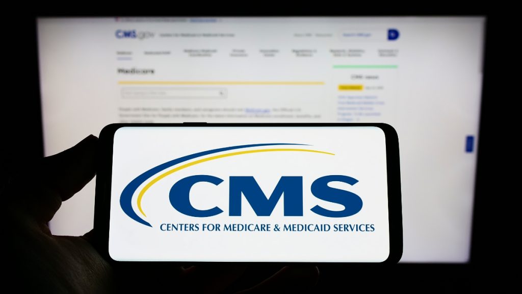 Mobile phone displaying the logo for the Centers for Medicare and Medicaid Services (CMS)