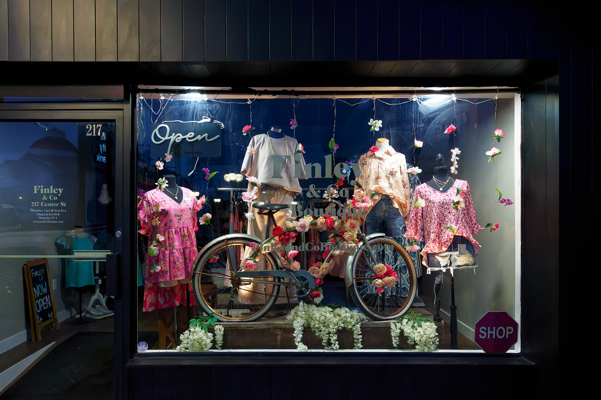 A storefront displaying a vintage bicycle alongside clothes